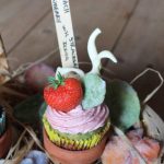 A spinach cupcake with strawberry frosting