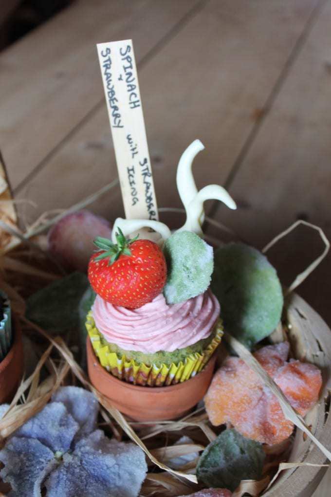 A cupcakes topped with a strawberry.