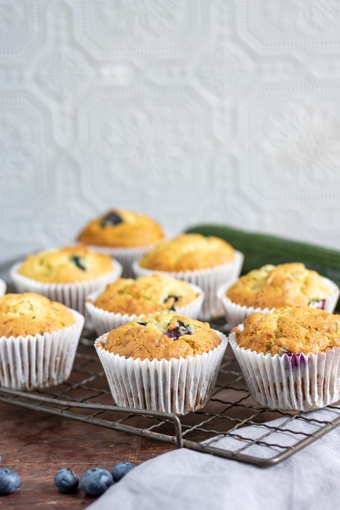 Zucchini muffins with blueberries on a vintage cooling rack