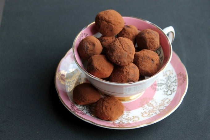 A vintage teacup full of chocolate truffles.