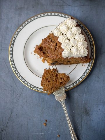 A slice of fluffy and moist easy carrot cake. This nut-free recipe is lighter with yogurt instead of half the oil.