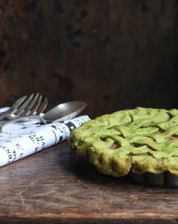 A green lattice pie on a wooden desk.  Apple Parsnip Cupcakes with Boozy Apple Ci ApplePieKalePastry e1499090744314 360x453