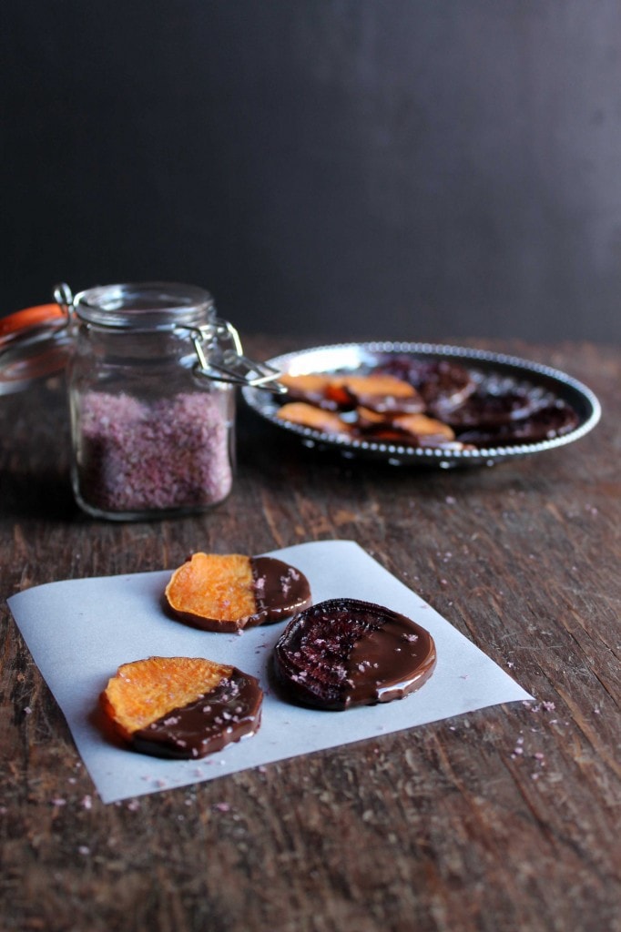 Chocolate covered beets and sweet potatoes on a paper.