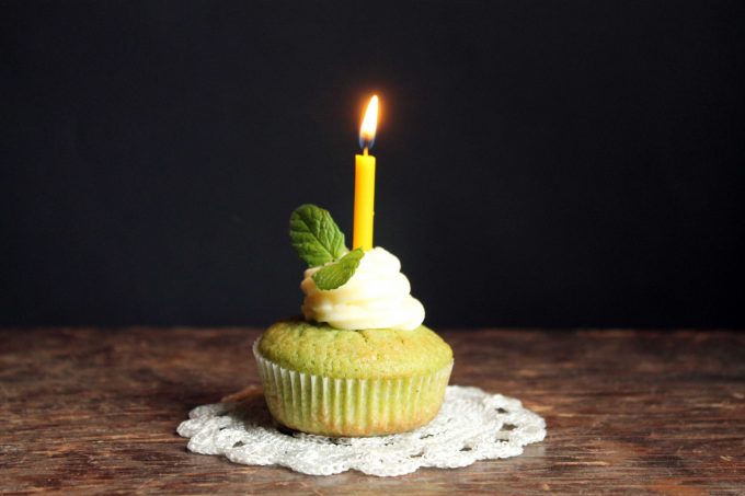 A cupcake with a lit candle.