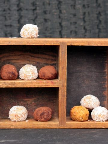 A wooden box full of sweet potato balls.