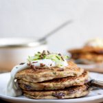 Zucchini pancakes with chocolate on a plate, topped with yogurt, courgette and chocolate