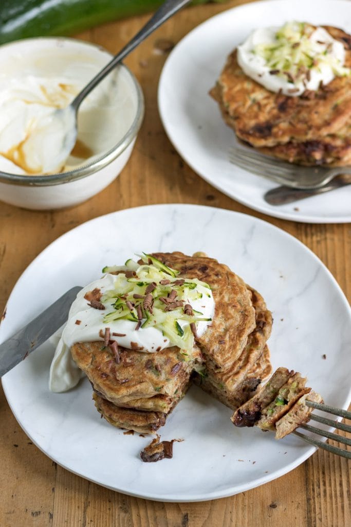 A stack of chocolate chip courgette pancakes with a bite taken out 