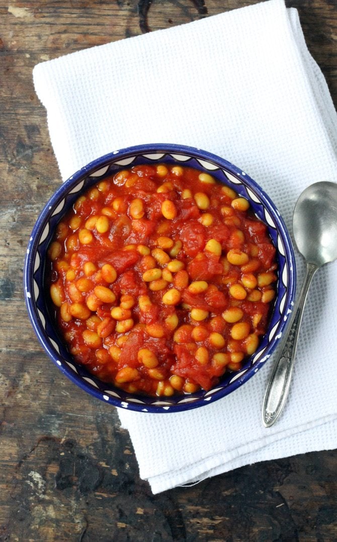 Bowl of baked beans on a table.