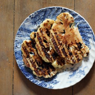 Slices of grilled cauliflower on a plate.