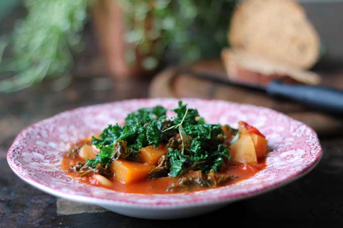 A bowl of stew on a table.