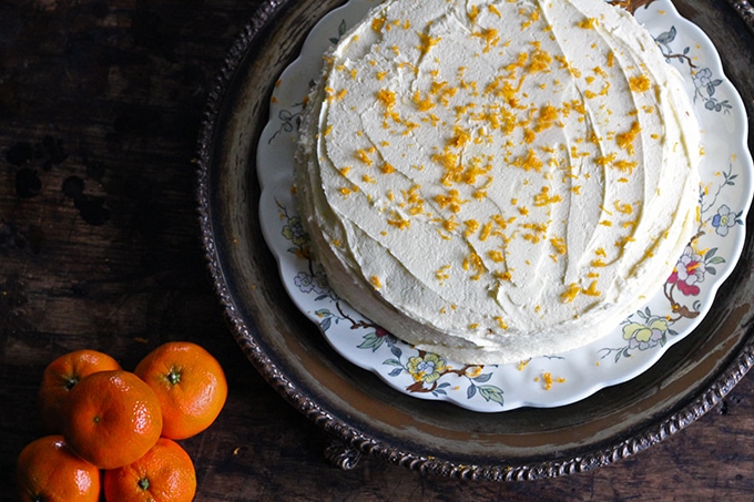 Looking down on a cake with buttercream and orange zest.