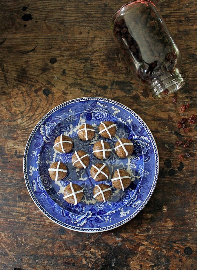 Hot cross balls on a vintage plate on a wooden table.