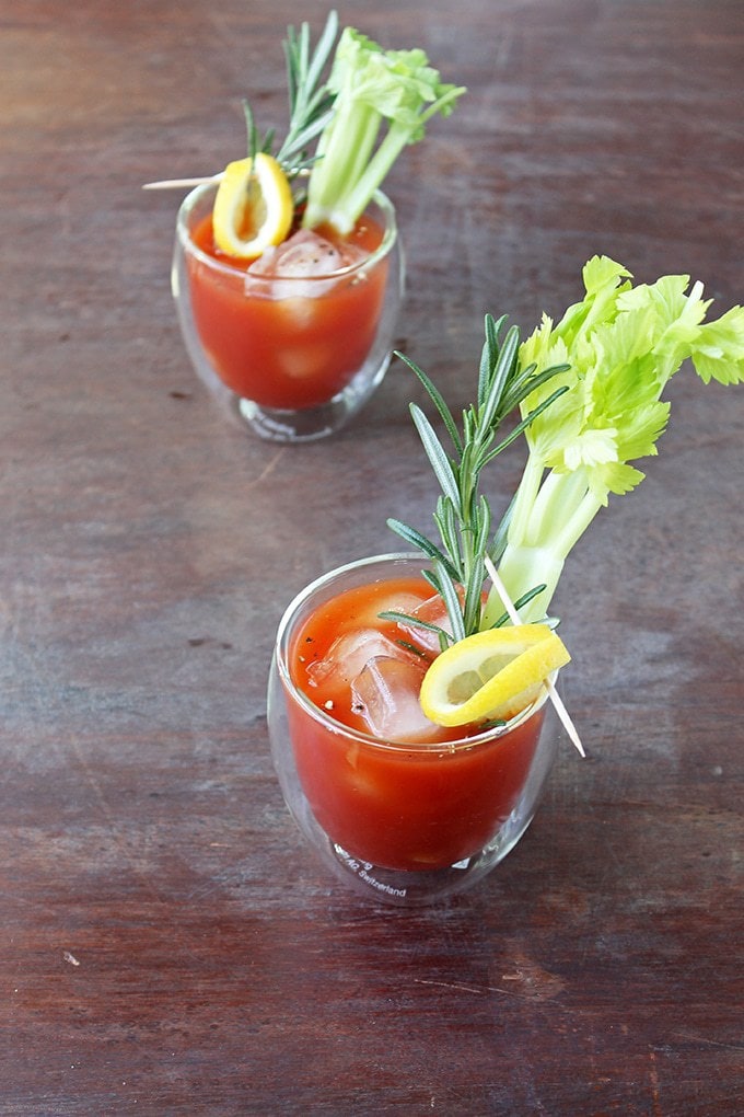 Two glasses of Bloody Mary with celery stalks.