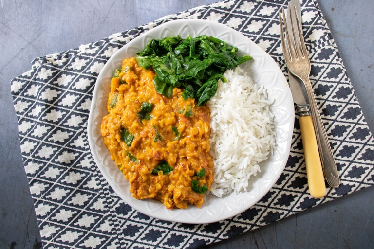 Plate of curry on a table.