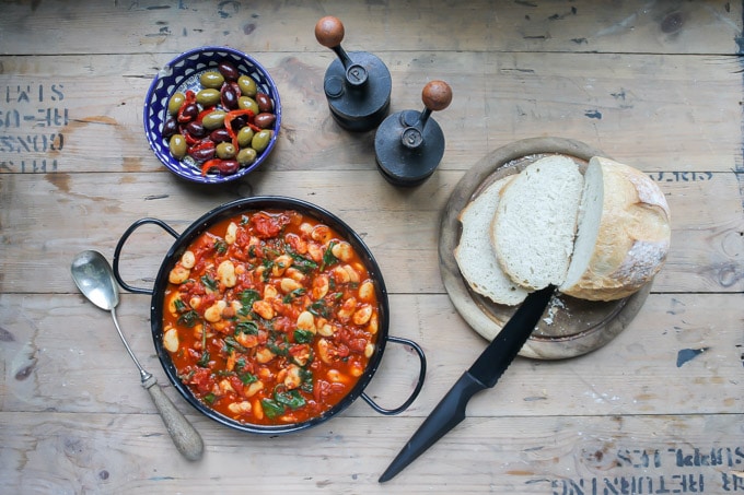 Overhead shot of Spanish Beans with a dish of olives. 