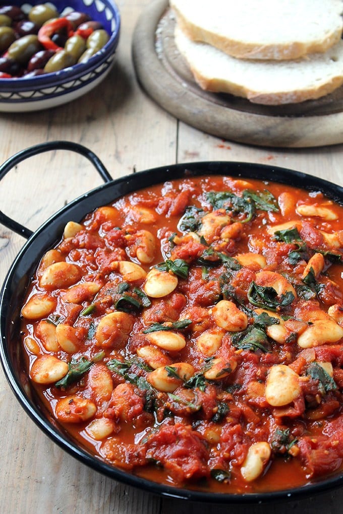 Serving dish of beans in tomatoes.