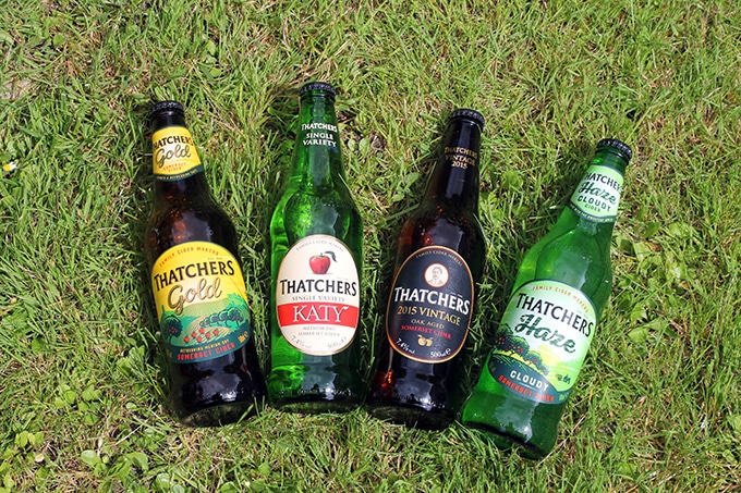 Bottles of cider in the grass.