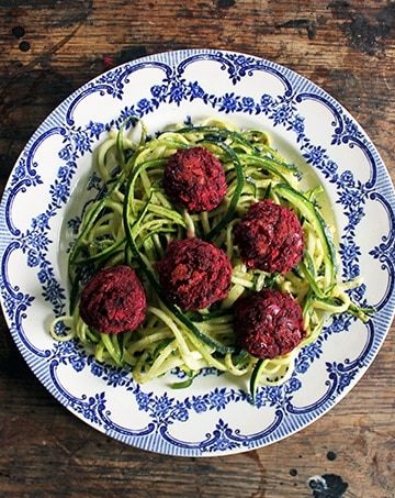 A plate of noodles and beet meatballs.