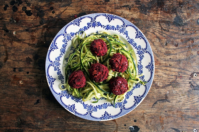 A plate of noodles and beet meatballs.