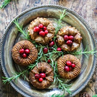 Mini bundt chestnut roasts on a vintage silver platter with cranberries piled on top with rosemary sprigs. Get the recipe.