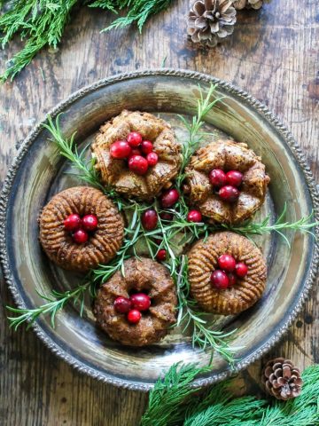 Mini bundt chestnut roasts on a vintage silver platter with cranberries piled on top with rosemary sprigs. Get the recipe.