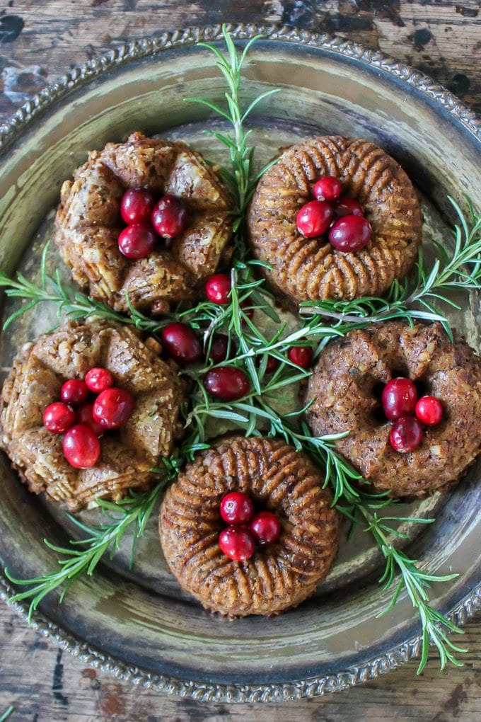 Close up of mini chestnut loaf (vegetarian and vegan) with fresh cranberries and sprigs of rosemary.