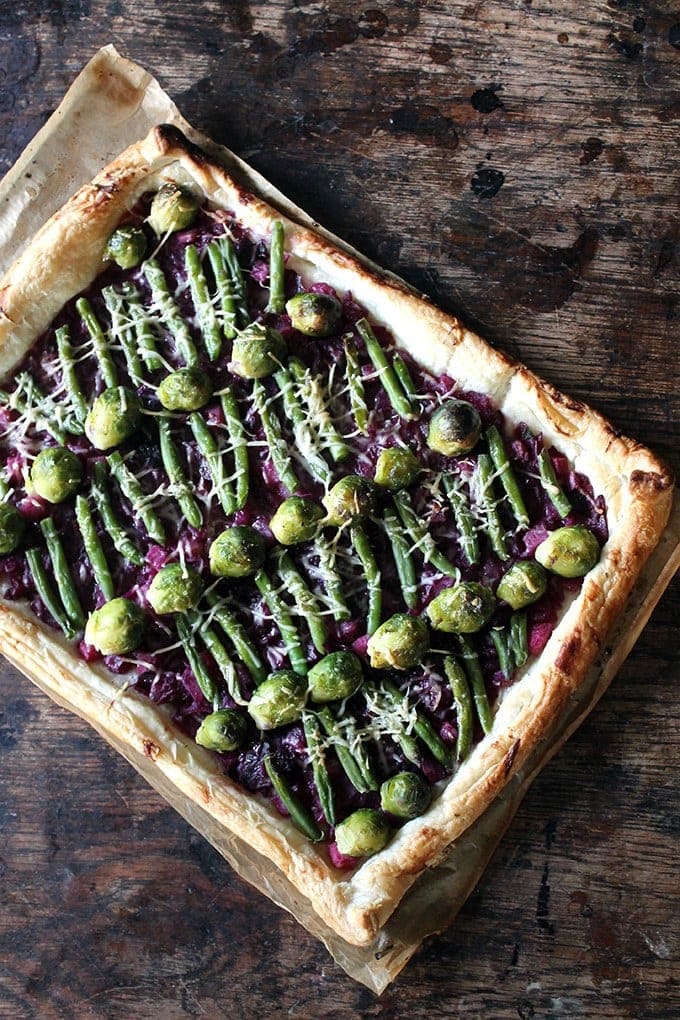 Tart with brussels sprouts and green beans on a bed of braised red cabbage.