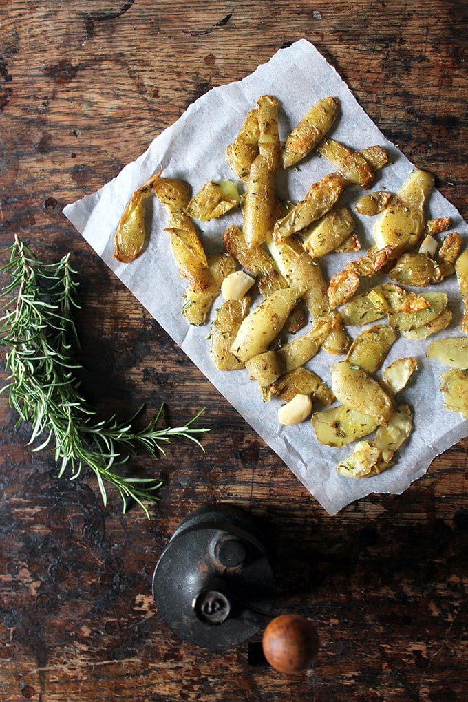 Roasted Potato Peelings with Rosemary and Sea Salt on a piece of baking paper