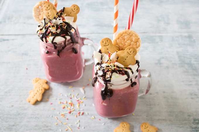 Vegan Vanilla Beet Freakshakes in glasses with coconut cream, sprinkles, chocolate sauce and cookies