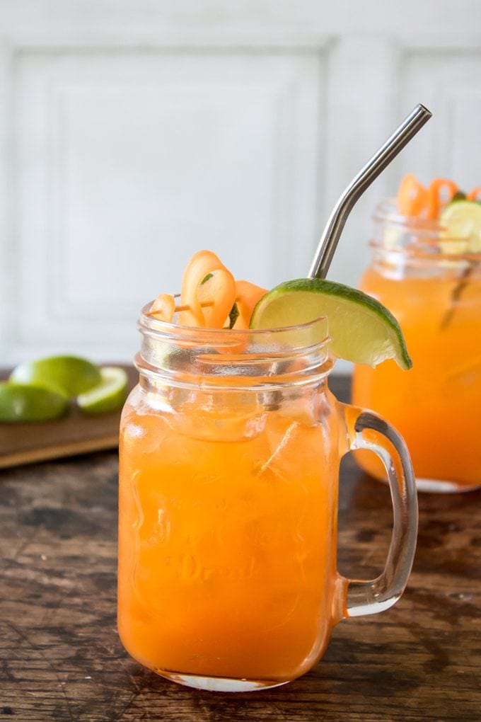 A glass of Carrot Moscow Mule cocktail - vodka, carrot juice, ginger ale and lime. 