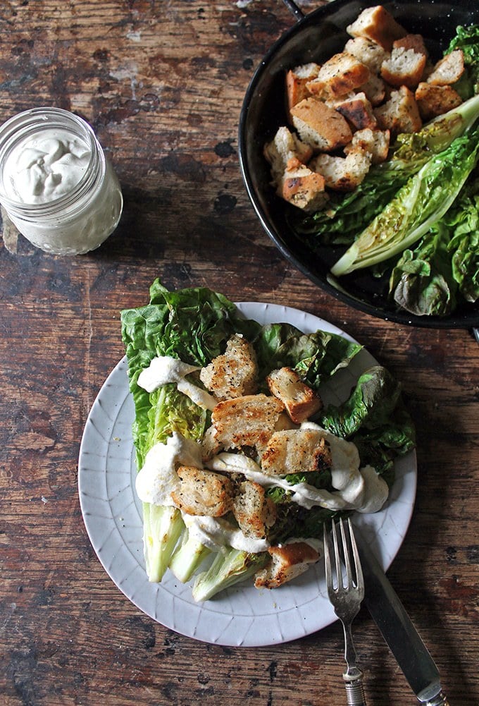 Salad on plates on a wooden table.