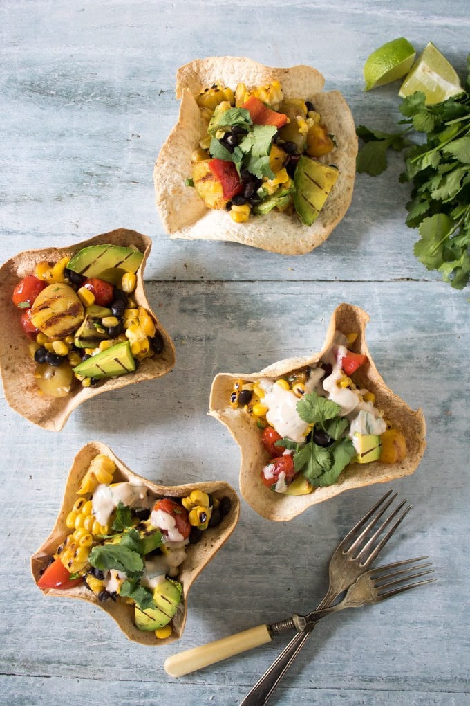 Tortilla bowls of salad on a table.