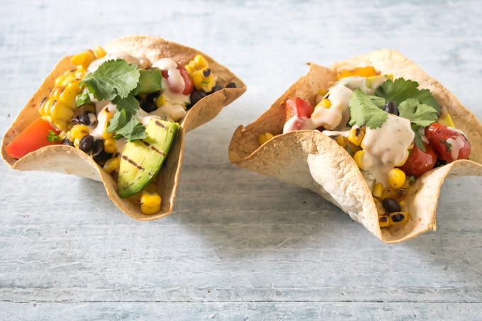 Two tortilla bowls full of Mexican Chipotle Grilled Salad.