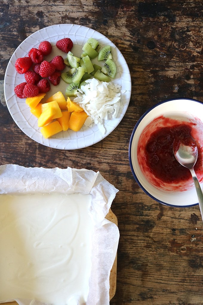 How to make Fruity Frozen Yogurt Bark - yogurt in a tray next to jam and fruit