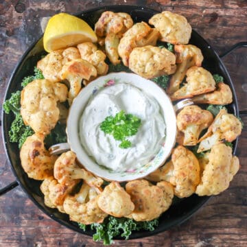 Serving dish of baked cauliflower wings.