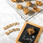 Granola bars on a rack, with a chalkboard that says: yummy.