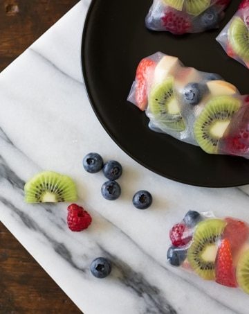 A marble board with fruit summer wraps.