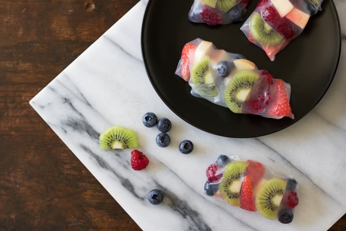 A marble board with fruit summer wraps.