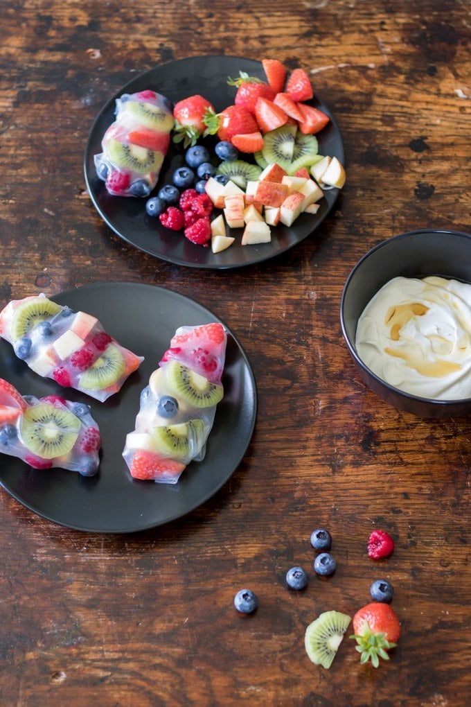Fruit Summer Rolls with Vanilla Yogurt Dip on plates with extra fruit