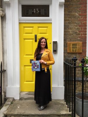 Kate Hackworthy in front of a publishing house door.
