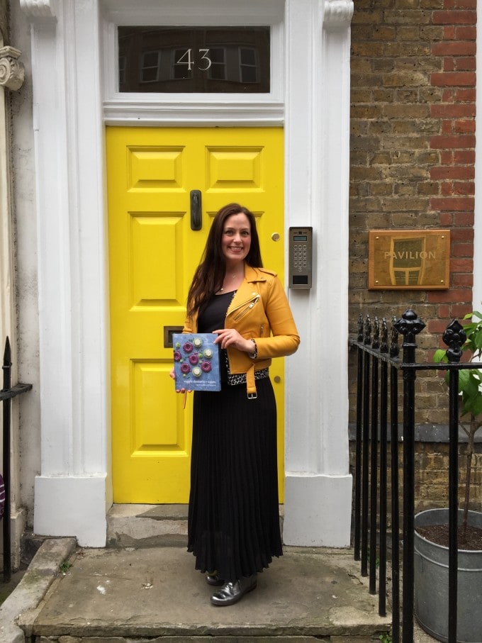 Kate Hackworthy standing in front of a door.