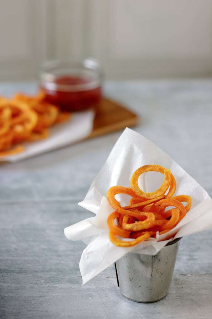 Spiralized sweet potato fries in a small silver pot