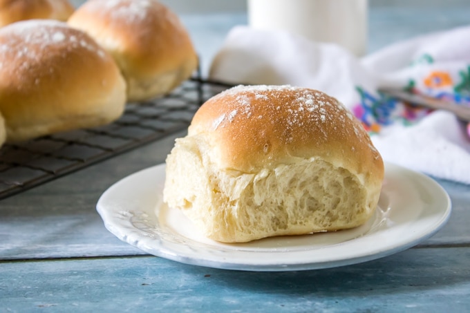 A close up of dinner roll on a plate.