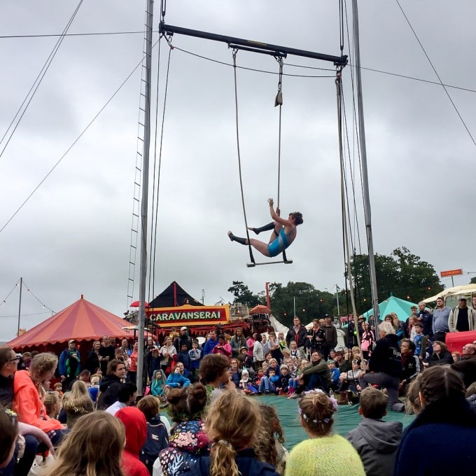 Trapeze artist and crowd below.