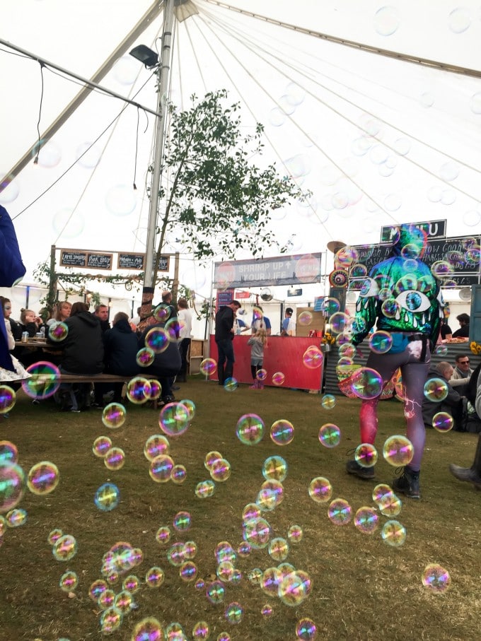 Inside a food tent at a festival, with bubbles in the air.