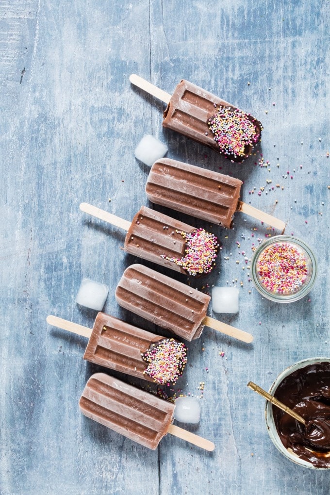 A row of popsicles with sprinkles.