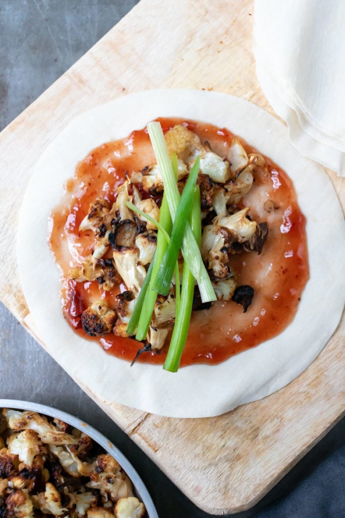 Vegan Chinese Crispy Duck made with cauliflower, served on homemade Chinese pancakes with plum sauce and strips of scallions. 