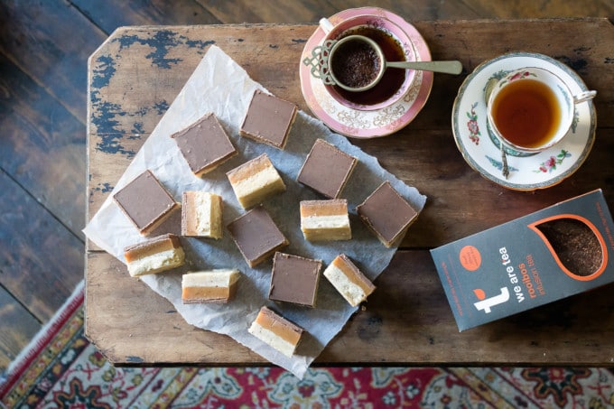 A table with millionaire shortbread and vintage teacups.