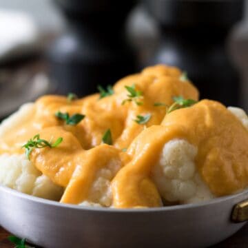 Dish of cauliflower with vegan butternut squash cheese sauce.