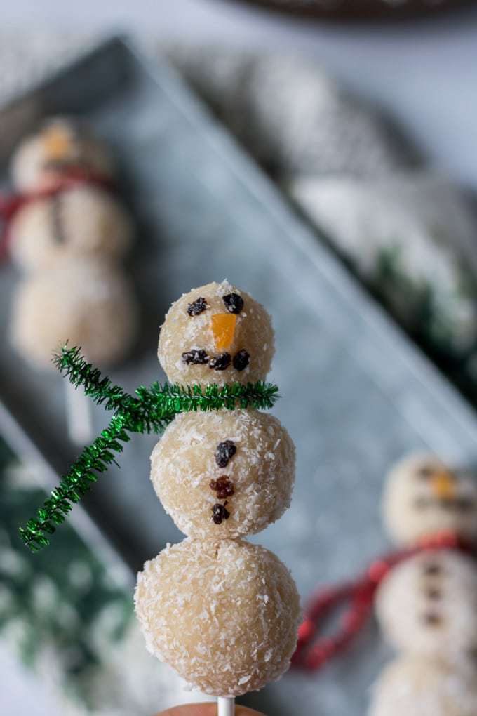 Coconut bliss balls threaded onto sticks and decorated to make fun snowmen